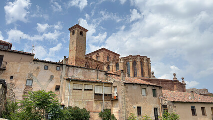 Fototapeta premium Catedral de Siguenza rises majestically over traditional Spanish houses under a cloudy sky