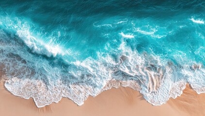 Fototapeta premium Aerial view of turquoise waves crashing on a beige beach