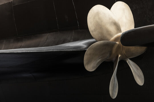 Ship Propeller Close-Up with Black Submarine Boat Hull Background