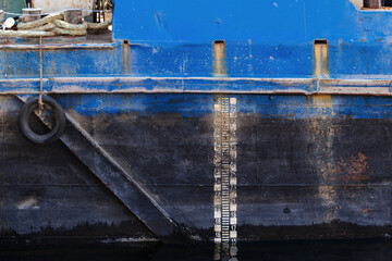 Close-Up View of a Rusty Ship Hull with Depth Scale Markers