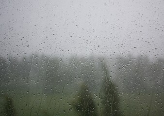 Raindrops on the window during a strong hurricane with wind in nature
