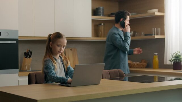Caucasian happy family morning at home man father walking talking mobile phone come in kitchen pouring fresh vitamin healthy juice in glasses girl kid child daughter studying using laptop media chat