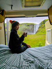 Relaxing with a coffee while enjoying the breathtaking view of Skogafoss waterfall in Iceland