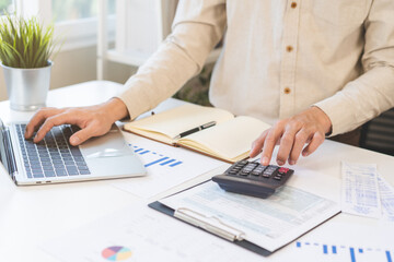 Account finance, asian young business man hand using calculator, laptop computer for calculate...