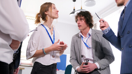 A young female company manager discusses with colleagues what to order for lunch. A group of...
