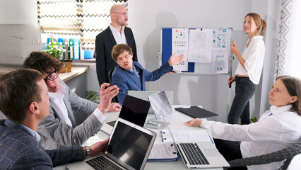 The head of the company called everyone together for a morning meeting. A group of business people...
