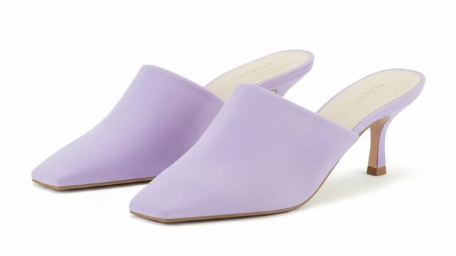 Two lilac heeled mule shoes on a white background