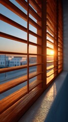 Obraz premium Sunlight streams gently through wooden blinds, casting golden rays across a room. The warm glow enhances the tranquil ambiance as dusk approaches, highlighting the day’s end
