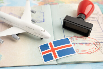 Iceland flag and passport with airplane for travel.