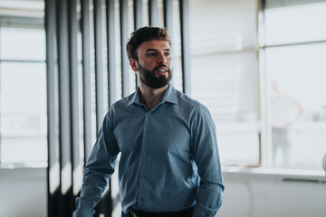 A confident businessman in a modern office, wearing a blue shirt, looking to the side. The setting...