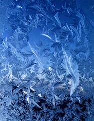 Icy Blue Frost Patterns Forming on Glass Surface in Winter Season Detail