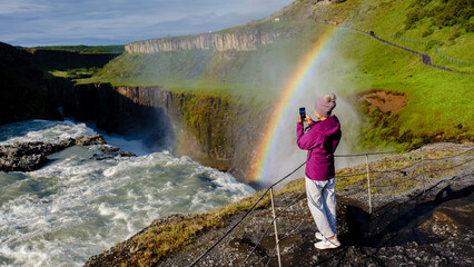 Captivating view of Gullfoss waterfall with a rainbow in Icelands stunning landscape