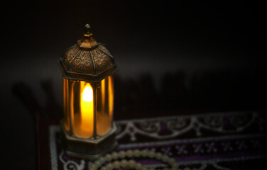 Islamic lanterns isolated on a dark background, the concept of Ramadan, Eid al-Fitr, and other Islamic holidays. Stunning Ramadan candle lanterns with free space