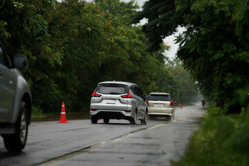 Cars drive on a flooded road after a storm in Thailand.