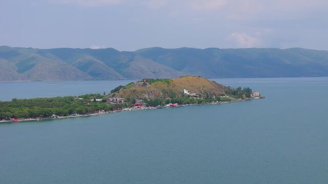 Aerial shot Sevan lake in Armenia, Caucasus. Drone shot ancient church Sevanavank (or Sevan monastery) in Armenia. Tourist, adventure, travel concept. Discovery, explore Armenia in West Asia.