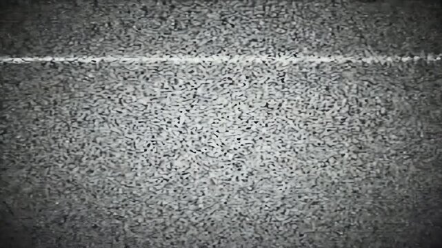 Grainy monochrome texture transitions, suggesting a damaged broadcast or memory lapse, symbolizing loss, decay, or fragmented recollection