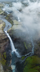 Majestic Haifoss waterfall cascades down rugged cliffs in Icelands stunning landscape