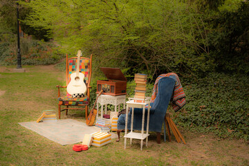 Cozy outdoor vintage setup with guitar books record player and chairs