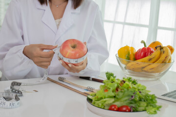 A female scientist in a lab coat is analyzing data on a laptop in a lab, researching medicine, DNA, chemistry, and healthcare with determination and confidence.