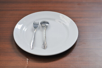 white ceramic plates, forks and spoons