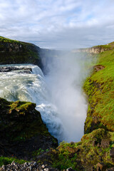 Majestic Gullfoss waterfall plunging into a rugged canyon in Icelands breathtaking landscape