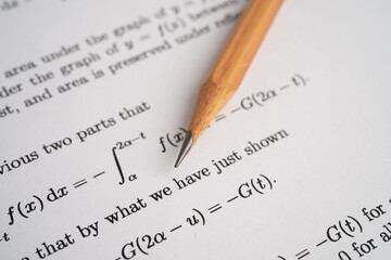 Pencil on mathematic formula exercise test paper in education school.