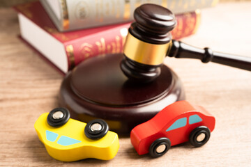 Car accident lawsuit and insurance, Judge hammer with car model.