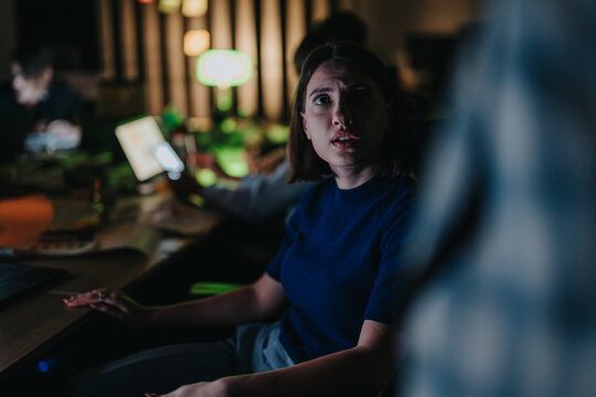 A diverse group of colleagues collaborating late at night, engaged in intense discussion and strategizing. They appear focused and determined while working on projects, aiming to meet tight deadlines. - Powered by Adobe