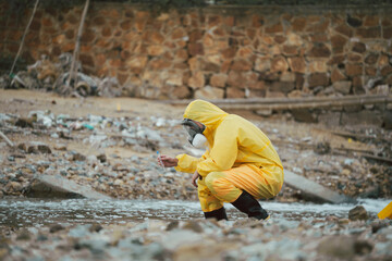 Environment scientist analysing waste water test results and collecting sample for research or...