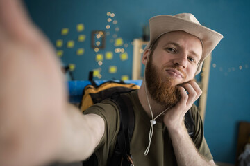 bearded traveler taking selfie before hike