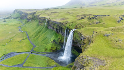 Majestic Seljalandsfoss waterfall cascading through lush green landscapes in Iceland