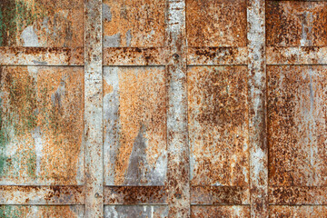 Rusty metal panels with grid pattern display expressive texture and vintage industrial mood, perfect for creative backgrounds or design.