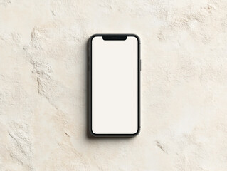 A silver smartphone with a blank white screen lies on a textured surface under soft lighting.
