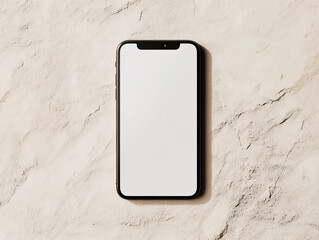 A silver smartphone with a blank white screen lies on a textured surface under soft lighting.