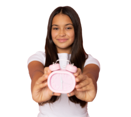 Young brunette girl wearing casual white t-shirt showing alarm clock over transparent background. PNG