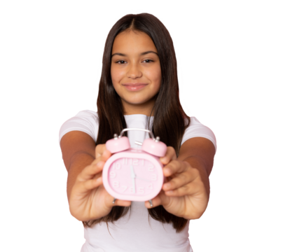 Young brunette girl wearing casual white t-shirt showing alarm clock over transparent background. PNG