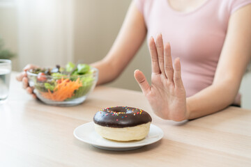 Women avoid to eat dessert while controlling their diet session.
