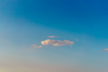 Background picture low angle of bright blue sky on a sunny day. There are fluffy white clouds and clear in soft tones. Feeling fresh, calm, and relax. Idea for heaven wallpaper with copy space.
