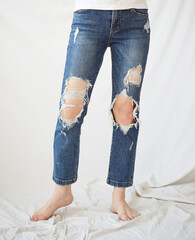 a woman in torn jeans.
