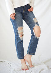 a woman in torn jeans.
