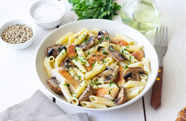 Penne pasta with chicken and mushrooms in creamy sauce. Italian cuisine. Recipe.