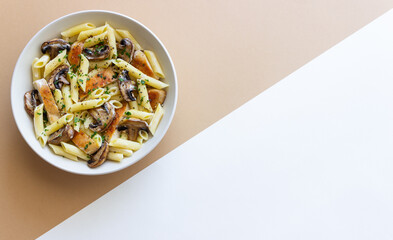 Penne pasta with chicken and mushrooms in creamy sauce. Italian cuisine. Recipe.