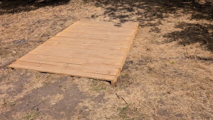 Wooden Deck Base Constructed on Dry Ground for Outdoor Relaxation and Recreational Use