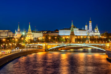 Moscow, Russia - 05 September 2021: View of the illuminated Kremlin towers and buildings reflecting on the dark, rippling surface of the Moscow River at night.