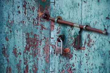 Rusty aqua blue door with modern lock                             