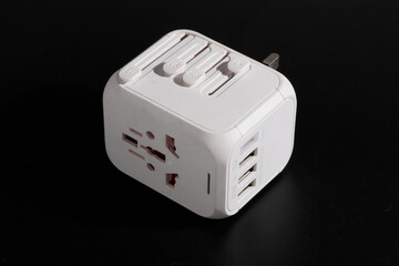 International universal traveller adaptor solutions - USB phone charger, normal UK 3 pin plug on black background