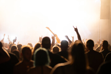 Crowd at concert and blurred stage lights.