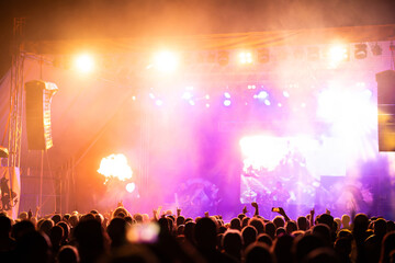 Crowd at concert and blurred stage lights.