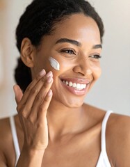 Woman applying face cream as part of her skincare routine, conveying beauty treatment and healthy skin.