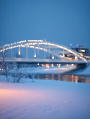 Obraz premium Snowy evening scene with a bridge illuminated by lights.
